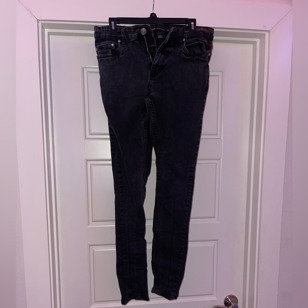 Skinny distressed black jeans.